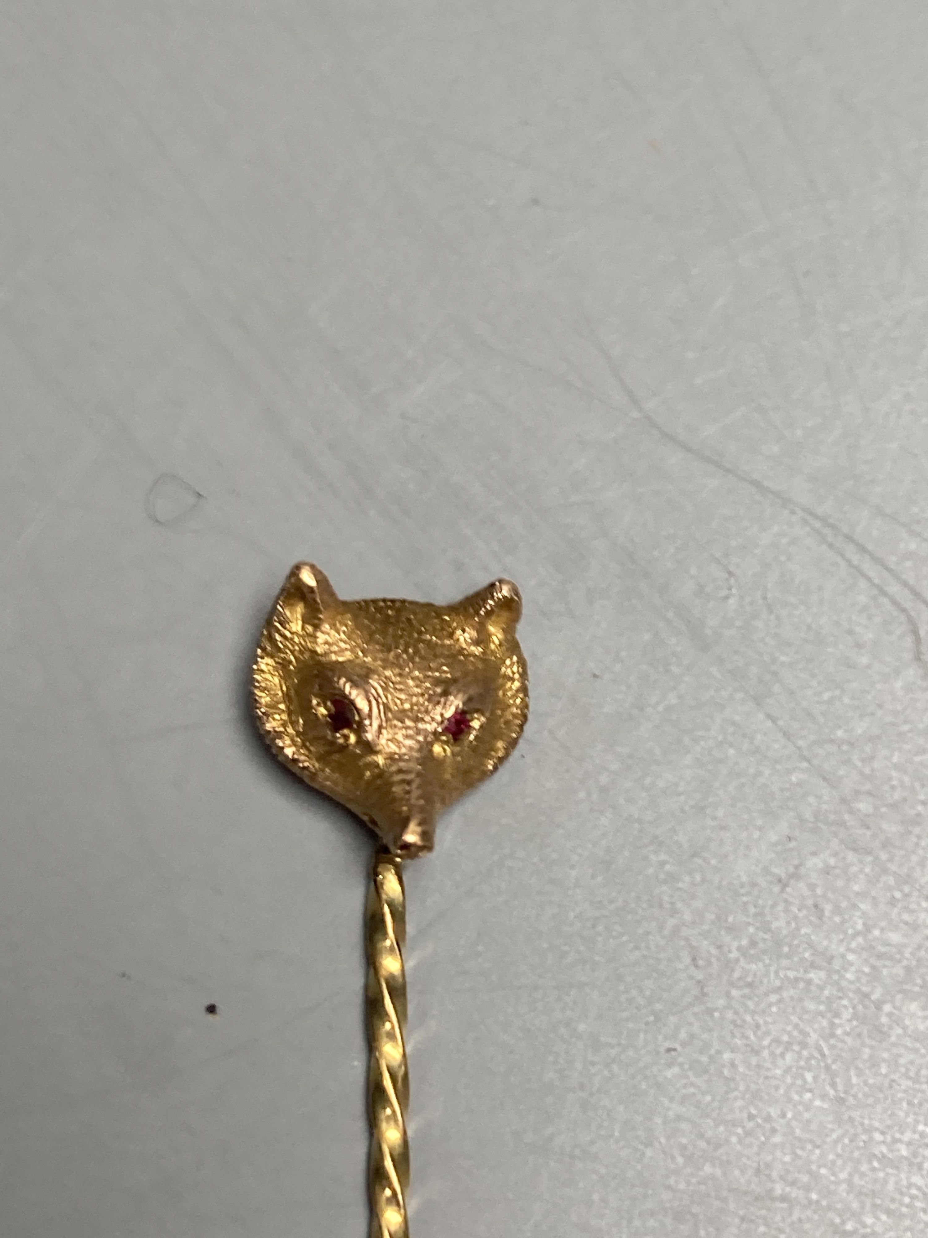 Four assorted late Victorian yellow metal stick pins and two tie pins.